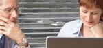 man and woman looking at computer