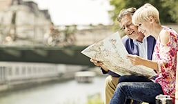 A couple looking at a map by the Seine