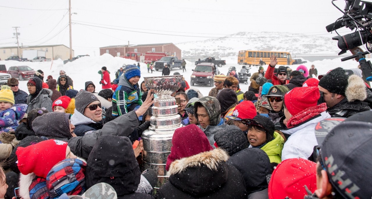 Excited residents surrounded the Stanley Cup® as soon as it arrived in Cape Dorset. Image courtesy of Michelle Valberg.