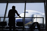 Business man looking at a plane
