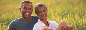 Elderly couple sitting on the grass