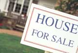 Front yard with “House for Sale” sign 