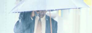Man talking on his cellphone in a rainy day