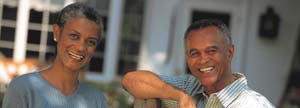 Elderly couple in front of their house