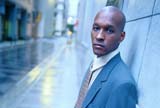 Young businessman next to a building