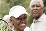 Elderly couple playing tennis