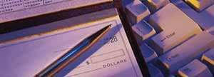 Cheque book over computer keyboard