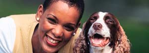 Woman and dog playing in park