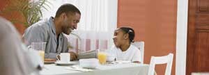 Girl having breakfast with her dad