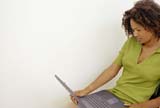 Young woman looking at her laptop