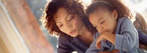 Woman helping her daughter with homework