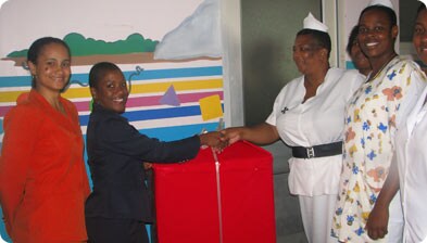 President of the Scotiabanks Staff Activities Committee, Joana Joseph (second from left) making the presentation to Sister Sampson. Looking on are Nicole Karam-Scotland (left) and PMH nurses. 
