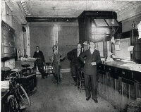 Men standing inside an old bank room
