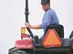Man driving a farm vehicle.