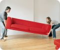 Couple lifting couch