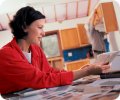 Woman looking at paint chips while husband installs cabinets