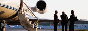 People on tarmac with plane