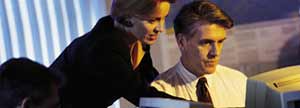 Business associates looking at a monitor.