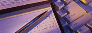 Cheque book on a computer keyboard.