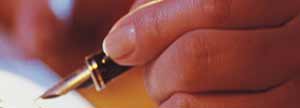 A woman's hand hold a pen.
