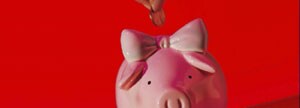 Penny being put in piggy bank