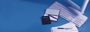 Computer, papers, pens and calculator