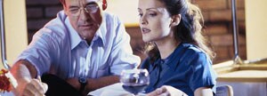 Couple doing paperwork with wine
