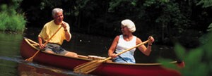 Couple padding a canoe
