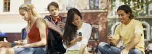 Four High School students w/cell phones