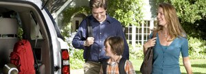Family packing back of vehicle 