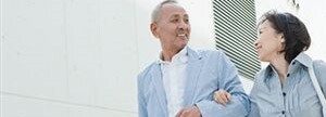 Mature Asian couple walking hand-in-hand