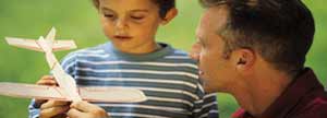 Father showing son a model airplane