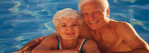 Retired couple pose in the pool