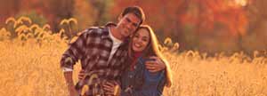 Couple posing in a field