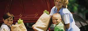 Mother and children unload groceries