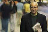Man on street holding newspaper