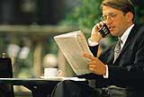 Businessman reading a newspaper.