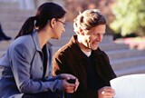Woman and man laughing in office.
