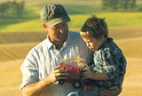 Father and son in a field.