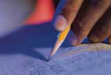 A person writing with a pencil.