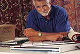 A man showing carpet samples.
