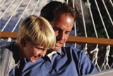 Father son on hammock with laptop