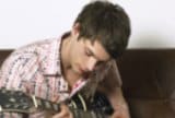 Teen playing guitar