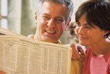 Couple reading newspaper