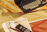 cell phone and laptop on papers