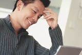 Man sitting at computer on home patio
