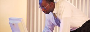 Business Man reading information in his computer