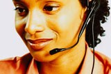 Woman smiling taking care of customers over the phone