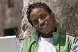 Young man with laptop smiling