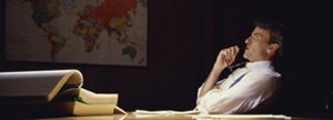 Man leaning back in chair, thinking